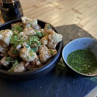 Crispy fried cauliflower with kimchi sesame seeds and Nuoc Cham dip sauce  at Munchie in Chamonix-mont-blanc