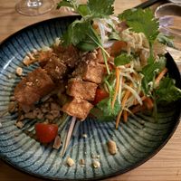 Tofu ”satay”, Som Tam salad,  thai basil, coriander, citrus salad, and crispy onion

  at Munchie in Chamonix-mont-blanc