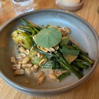 CHINTEXTLE GREEN BEANS
‍Green beans in a vibrant ancho-tahini ponzu, balanced with earthy greens and roasted peanuts at Madre in Amsterdam