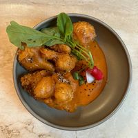 CHIPOTLE MOLE CAULIFLOWER WINGS
‍Cauliflower wings with a rich chipotle mole perfectly spiced made of white chocolate, tomatoes, almonds and chipotle  at Madre in Amsterdam