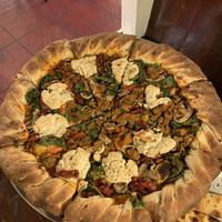 Build your own large pizza with stuffed crust, cashew ricotta, spinach, mushrooms, roasted tomatoes, and pink sauce  at Pi Vegan Pizzeria in Seattle