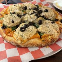 My favorite one!! House cheese with sun dried tomato sauce , spinach, olives, and potatoes! Definitely recommend.  at Pi Vegan Pizzeria in Seattle