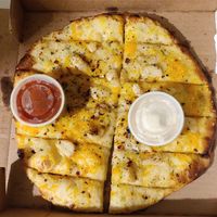 Cheesy garlic bread with garlic and marinara sauces at Pi Vegan Pizzeria in Seattle