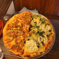 Half meat-lovers, half sunny day (yes those are potatoes 😍) at Pi Vegan Pizzeria in Seattle