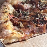 Their vegan stuffed crust pizza with pepperoni, sausage, and sun dried tomatoes   at Pi Vegan Pizzeria in Seattle