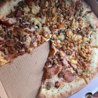 Half pad Thai pizza, half pepperoni, sausage, and sun dried tomatoes- with a stuffed crust.   at Pi Vegan Pizzeria in Seattle