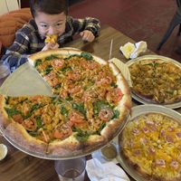 Butter chikin, Thai chikin and mac and cheese pizzas  at Pi Vegan Pizzeria in Seattle