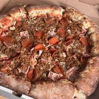 Vegan meat lovers with sun dried tomatoes, mushrooms, with a stuffed crust.   at Pi Vegan Pizzeria in Seattle