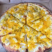 While garlic base w/mozzarella, cheddar, and pineapple   at Pi Vegan Pizzeria in Seattle