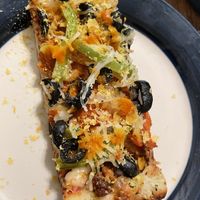 Some nooch sprinkles & homemade hot sauce makes it 🤌🤌🤌  at Pi Vegan Pizzeria in Seattle