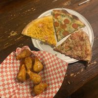 Wings and pizzaa  at Pi Vegan Pizzeria in Seattle