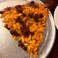 mac & cheese pizza topped with sausage at Pi Vegan Pizzeria in Seattle