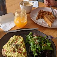 Avocado toast with seeds and some greens, waffles with peanut butter, oat milk latte 😀👍 at The Coffee Studio in Lagos