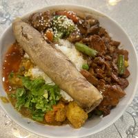 Spiced peanut, mushroom soy nuggets, and lentil curry on rice. Topped with a spring roll. 😝  at HeartFood in Hobart