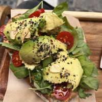 Toastado with avocado, hummus, tomatoes, seeds and fried slices of garlic  at Sur Coffee Corner in Granada