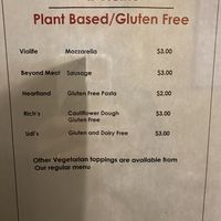 Paper posted of specific brands used on vegan and gluten-free pizzas  at IL Vicino in Santa Fe