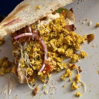 Half eaten breakfast sandwich  at Plant Based Paradise Kailua in Kailua