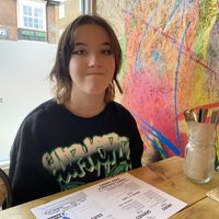 Happy young lady at VK Plant Based Diner in Waterlooville
