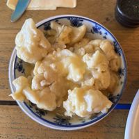 Cauliflower cheese on the sidee  at VK Plant Based Diner in Waterlooville