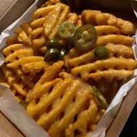 Loaded vegan fries, with vegan melted cheese and jalapeños at Leon in Cobham