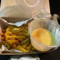 Loaded waffle fries with hot melted cheesy sauce at Leon in Cobham