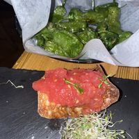 Fried baby green peppers and Toasted homemade artisanal bread with tomatoes and garlic at Eatapas in Fort Lauderdale