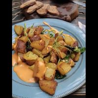 Vegan golden potatoes and vegan appetisers with homemade bread .  at DaOrganic restaurant in Sofia