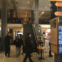 Food hall, with tables upstairs. at Playa Bowls - Lexington in New York City