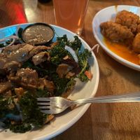 Buffalo Cauliflower bites, Grilled Kale and Beet salad with seitan sub and no cheese  at Lucky's Taproom and Eatery in Dayton