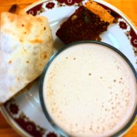 Chai latte (oat milk), sharing burrito and cake  at Earthlings in Newcastle Upon Tyne