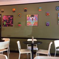 paintings on the wall in the cafe. love the one of david wolfe! at PuraVegan in St Louis
