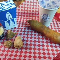 Left: Meteoritos (like popcorn chicken) Right: Deep-fried sausage on stick covered in batter at Stankov - Chapinero in Bogota