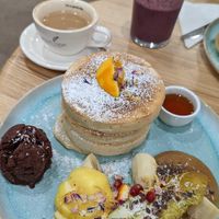 Pancakes, ice cream, fruits, pear puree, maple syrup at Good One Café in Hamburg