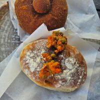 Deep fried and baked savory buns with filling inside, served warm at Matteotti Café in Palermo