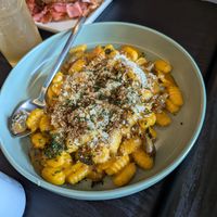Kabocha Gnocchi in foreground with a Root Reuben in the background. at Gladys  in Edgewater