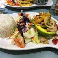 Stuffed avocado with vegan chicken and peppers, salad, rice, and black beans at Eileens Kitchen  in San Juan