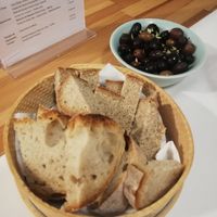 Bread basket and olives at Hostel Retiro do Gerês in Fafiao