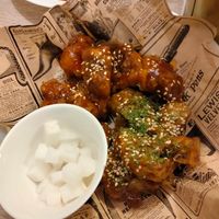 Korean street style deep fried cauliflower with 1/2 soy garlic sauce and 1/2 lemon basil sauce and pickled daikon on the side at Mama Bowls in Arnhem