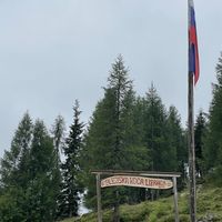 Welcome sign and Slovenian flag.  at Krekova koča na Ratitovcu in Torka