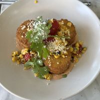 Leo’s Cakes: hash cakes with guacamole, tomatoes, and ancho crema  at Beach'n SF in San Francisco