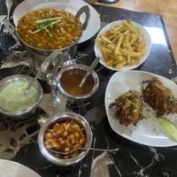 Our mains with chips and onion bhajis as a side   at Curry 'n' Grill House in Tenerife