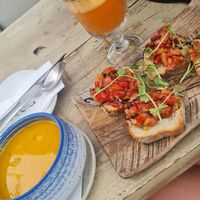 Carrot/cilantro soup, tomato&garlic bruscetta and fresh carrot, ginger, apple juice at U Bistrot in St Julians