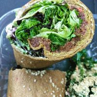 Burrito with walnut meat and kale salad in the background at Good Life Cafe in Columbia