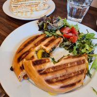 Pesto Bagel and Russian Honey Cake in the background at Nama Café and Cake House in South East London