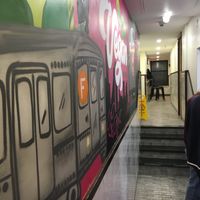 Long hallway where you order, pick up good, and stools to it in the back. at Vegan On The Fly in New York City