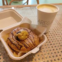 Cookie dough doughnut and big coffee with sou milk at Areca Bakery in Barcelona