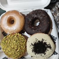 Donut glaseado, de chocolate, de pistacho y de oreo at Areca Bakery in Barcelona