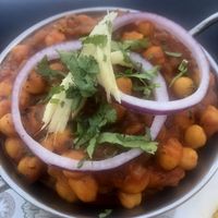 Chick peas cooked with onion, tomato and herbs    at Happy Flavors in Fuengirola