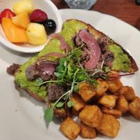 Avacado toast with impossible lardons and cashew cream cheese with a side of potatoes and fruit at Eden in Hot Springs