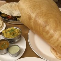 Paper dosa + vegan thali in background at Sagar Vegan & Vegetarian Restaurant - Covent Garden in London